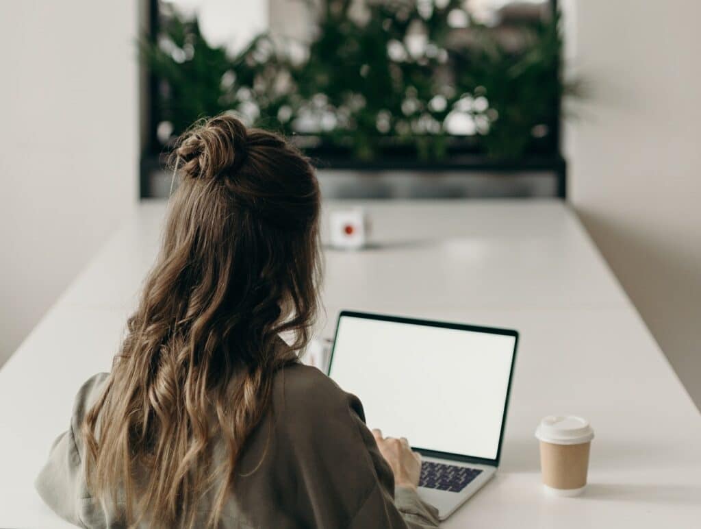 woman writing storytelling marketing email on laptop