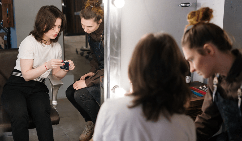 woman in chair signing up for salon referral program