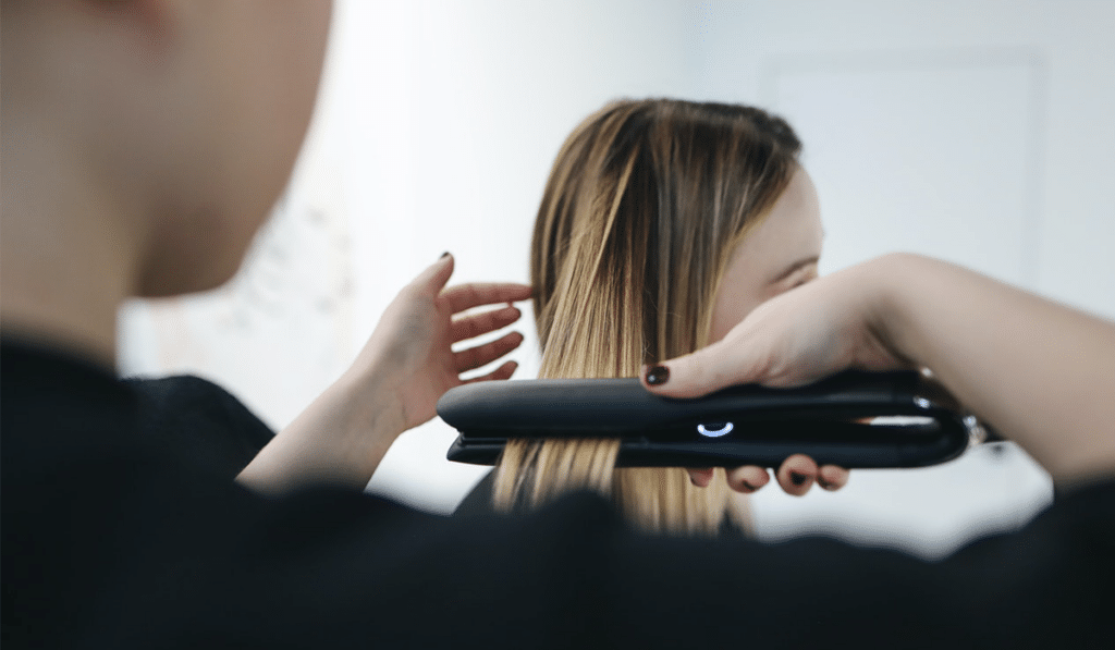 person getting hair straightened because of Salon Customer Loyalty